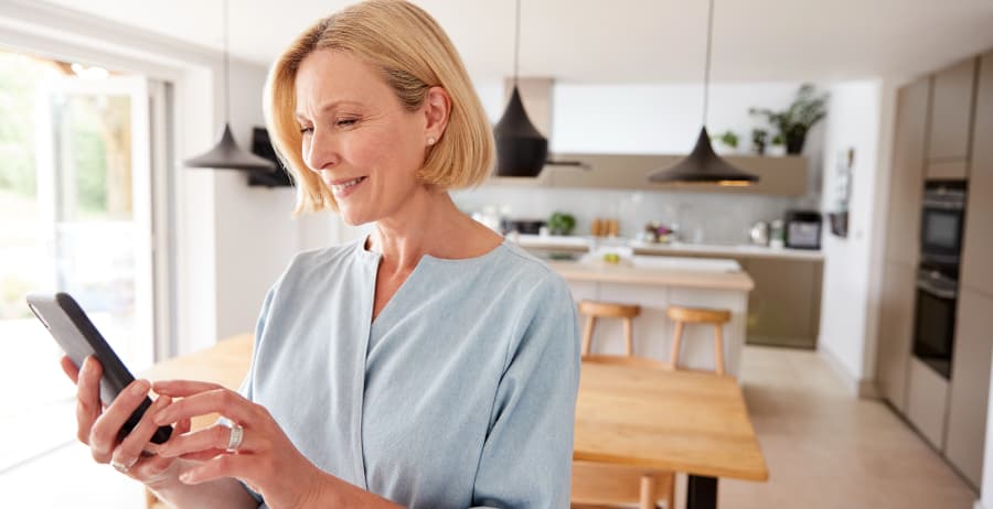 Woman with smartphone in a modern home